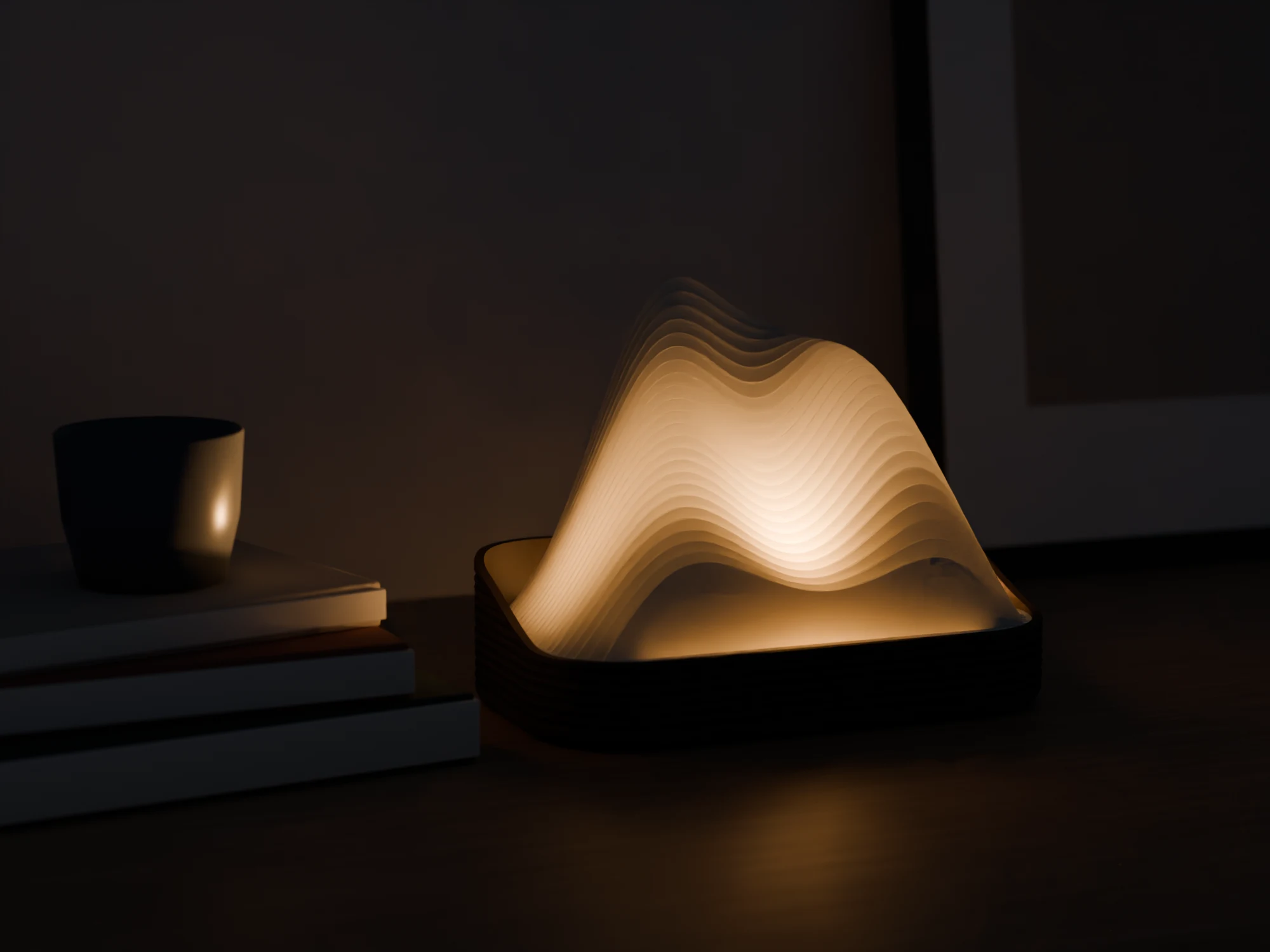 Lamp in de vorm van een heuvellandschap die in het donker warm licht geeft